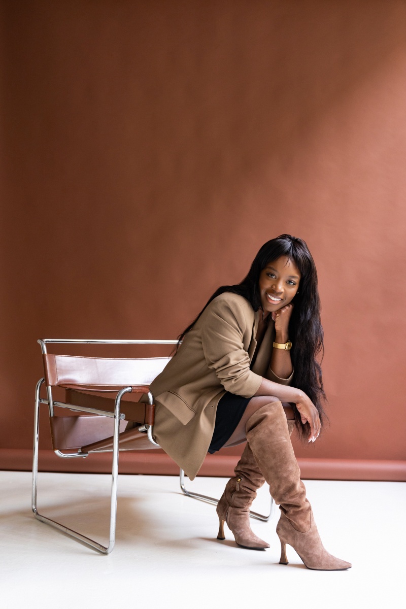 Ursula black woman leaning over chair professional