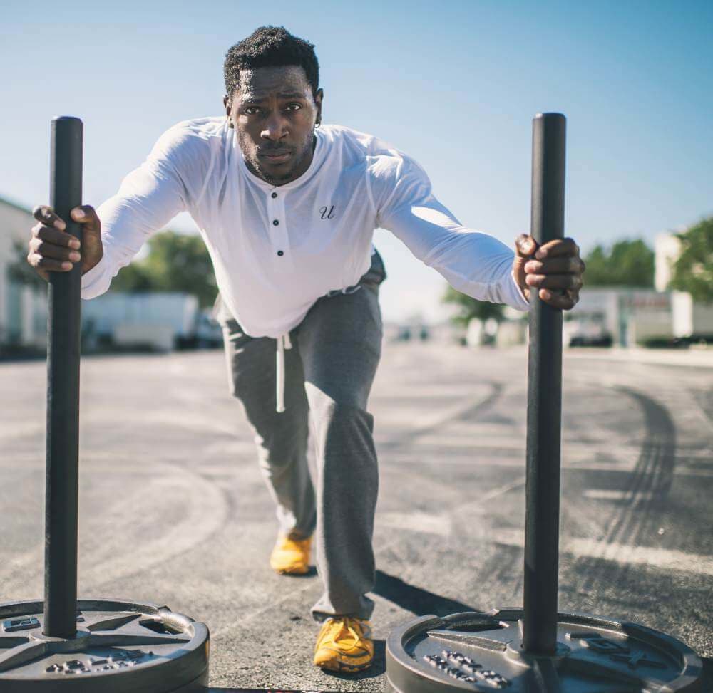 fitness-black-male-sweat-exercise-dubmbells-outside-capitol-standard