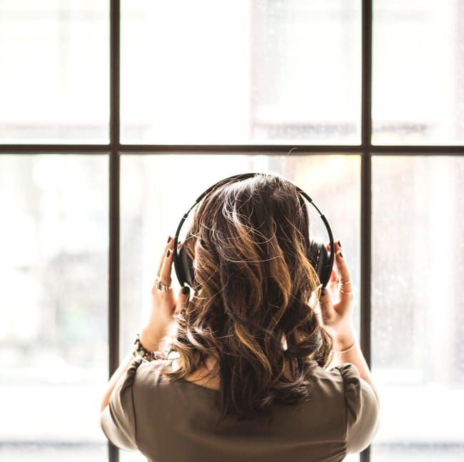 looking-out-window-wearing-headphones-best-podcast-washington-dc
