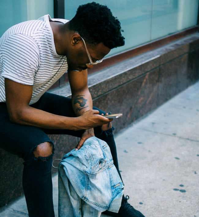 make-friends-as-an-adult-after-30-in-a-new-city-black-man-on-phone