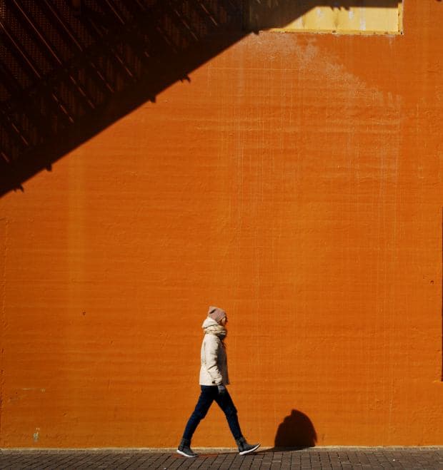 where-to-cry-in-dc-woman-walking-orange-wall-mary-deraedt