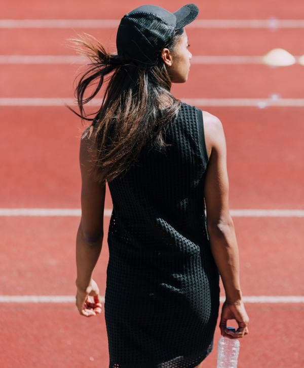 why-i-love-networking-at-the-gym-margaret-greco-woman-running-track-water-bottle-sporty