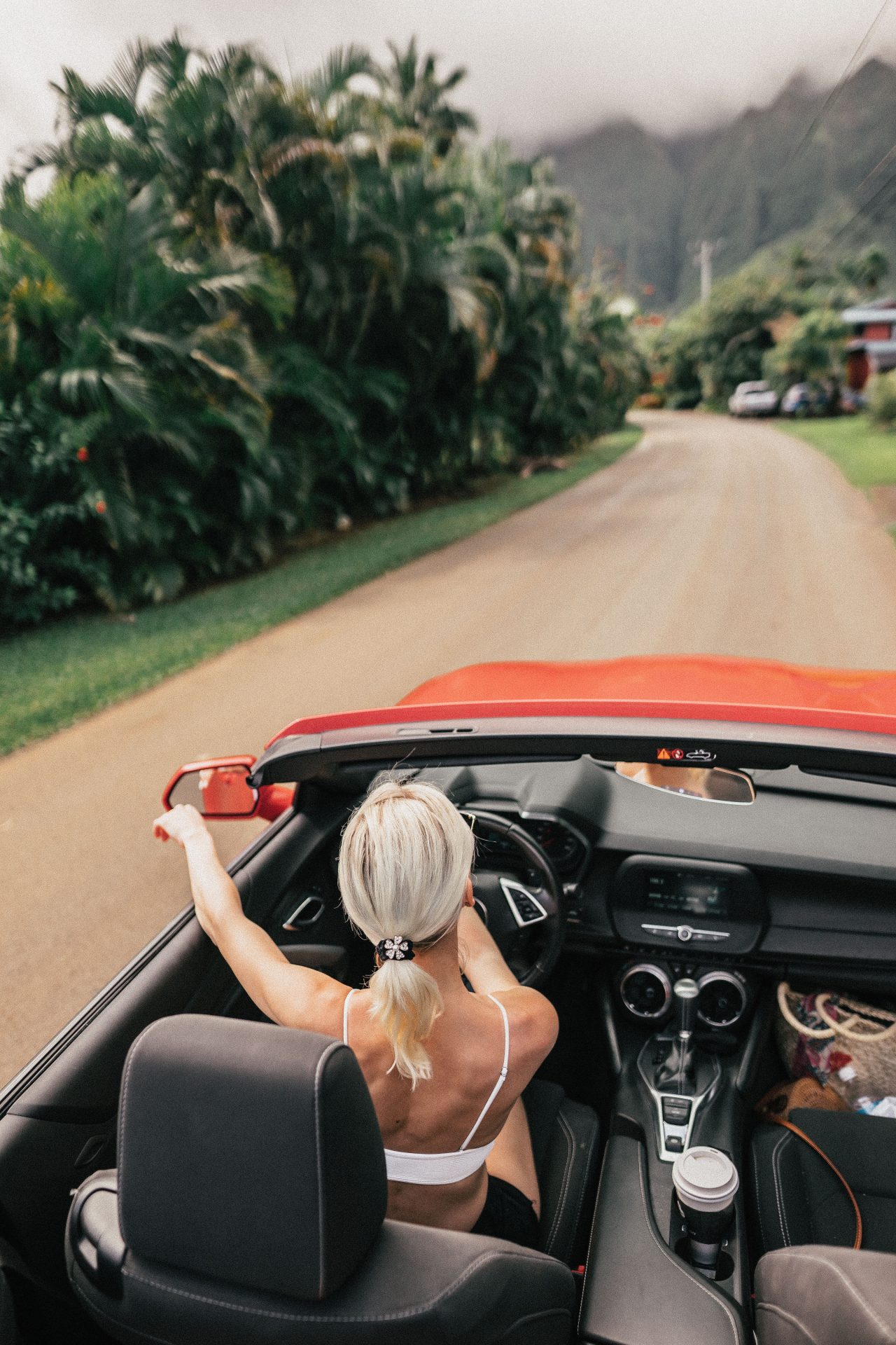 move-to-hawaii-moved-to-hawaii-what-to-know-economy-cost-of-living-woman-in-car-convertible-road