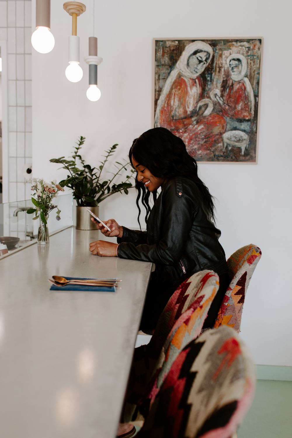 black-woman-smiling-sitting-using-phone-personal-career-brand