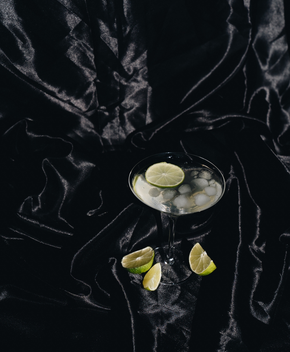 nye-new-years-eve-2020-alone-low-key-at-home-photo-of-cocktail-glass-on-black-silk-fabric