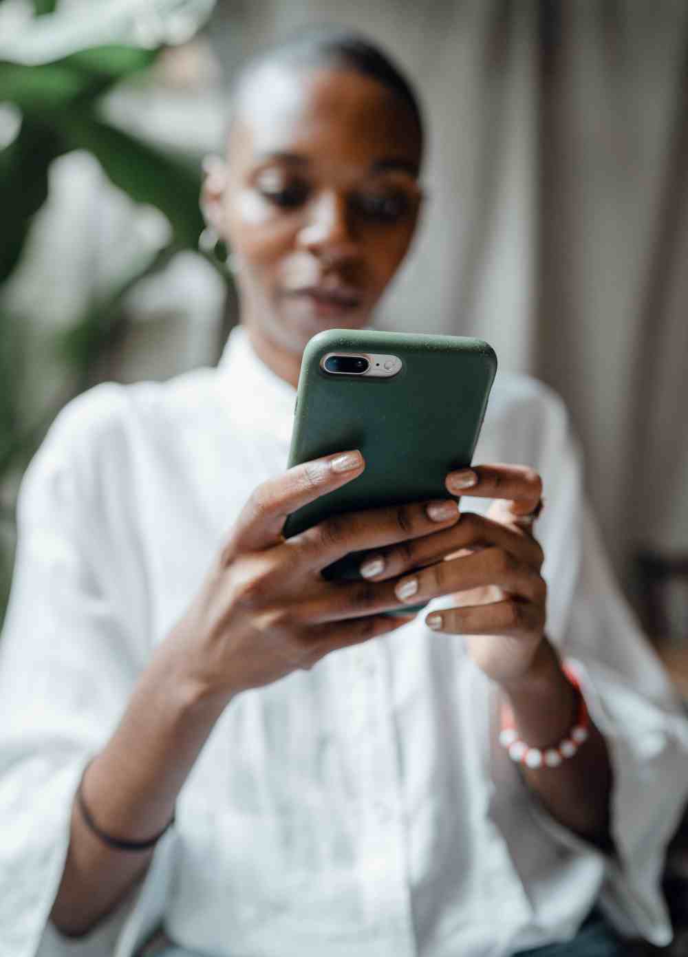 work-from-home-habits-woman-black-cell-phone-Article_14